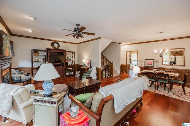 2418 Richelieu Ln, Hoover, AL 35216 - living room featuring stairs, ceiling fan, a wainscoted wall, a chandelier, and crown molding