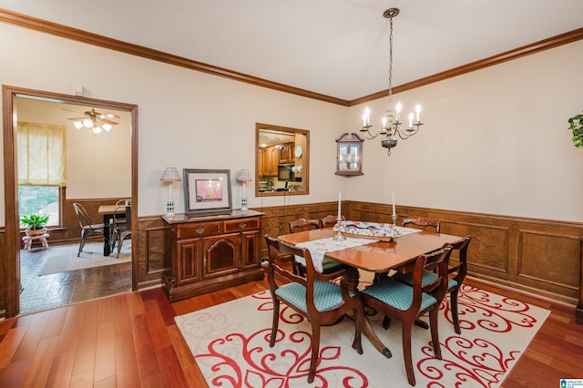 2418 Richelieu Ln, Hoover, AL 35216 - dining area featuring wainscoting, ornamental molding, a chandelier, dark wood finished floors, and wood walls