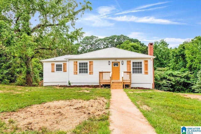 1818 Hillcrest Rd NE, Center Point, AL 35215 - view of front of house with a chimney, a front lawn, and a metal roof