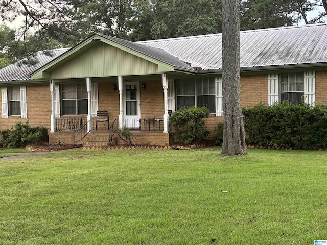 812 2nd Ave, Pleasant Grove, AL 35127 - ranch-style home with brick siding, a metal roof, a porch, and a front yard