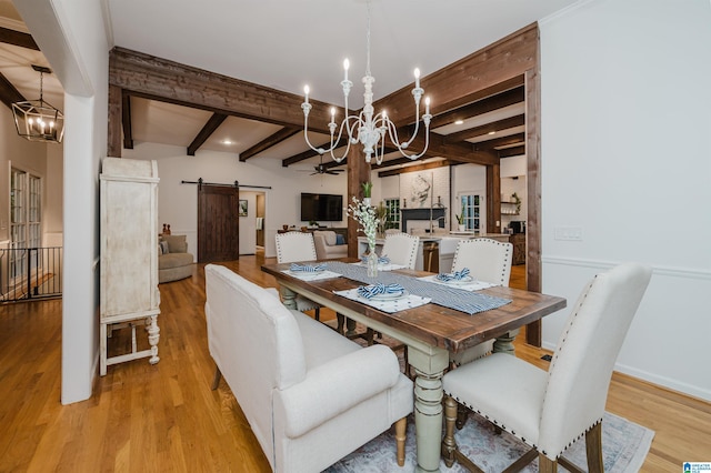 3204 Woodford Way, Birmingham, AL 35242 - dining space featuring a barn door, a chandelier, light wood-style flooring, and beam ceiling