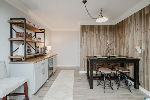 3204 Woodford Way, Birmingham, AL 35242 - dining room with wine cooler, crown molding, light wood-type flooring, wooden walls, and a bar