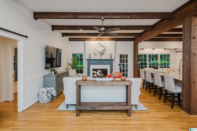 3204 Woodford Way, Birmingham, AL 35242 - living room with light wood finished floors, a brick fireplace, ceiling fan, and beam ceiling