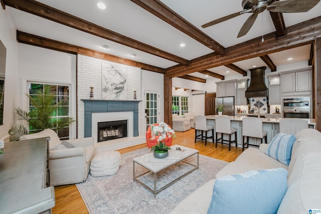 3204 Woodford Way, Birmingham, AL 35242 - living room featuring light wood finished floors, beam ceiling, a ceiling fan, a brick fireplace, and recessed lighting