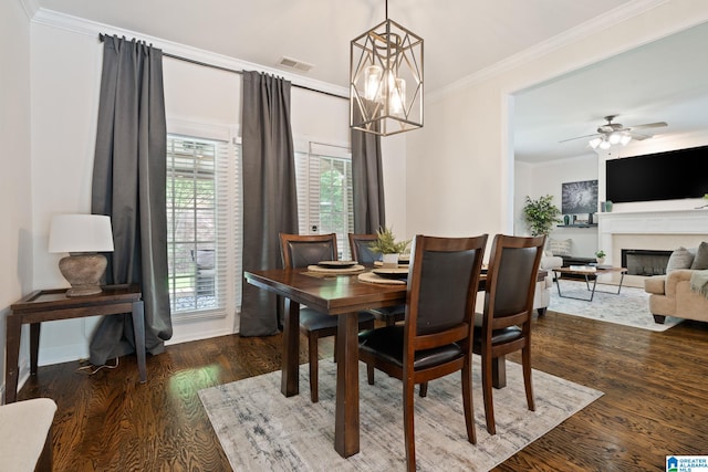 5912 Waterscape Pass, Hoover, AL 35244 - dining area with ornamental molding, a fireplace, wood finished floors, a chandelier, and a ceiling fan