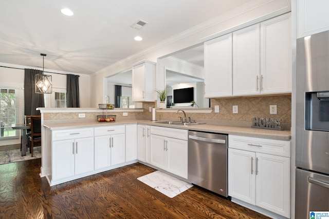 5912 Waterscape Pass, Hoover, AL 35244 - kitchen with stainless steel appliances, dark wood finished floors, light countertops, white cabinetry, and ornamental molding