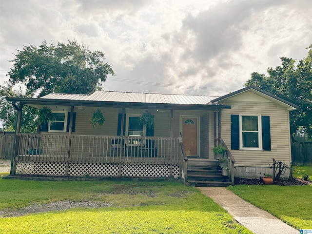 104 Phillips Cir, Columbiana, AL 35051 - view of front of property featuring a porch, a front lawn, crawl space, and a metal roof