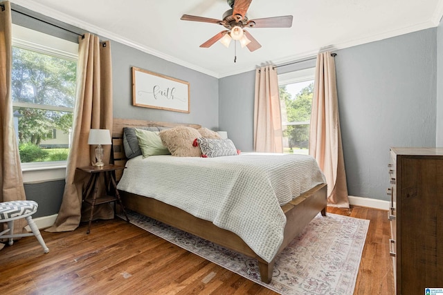 104 Phillips Cir, Columbiana, AL 35051 - bedroom with multiple windows, ornamental molding, wood finished floors, and a ceiling fan