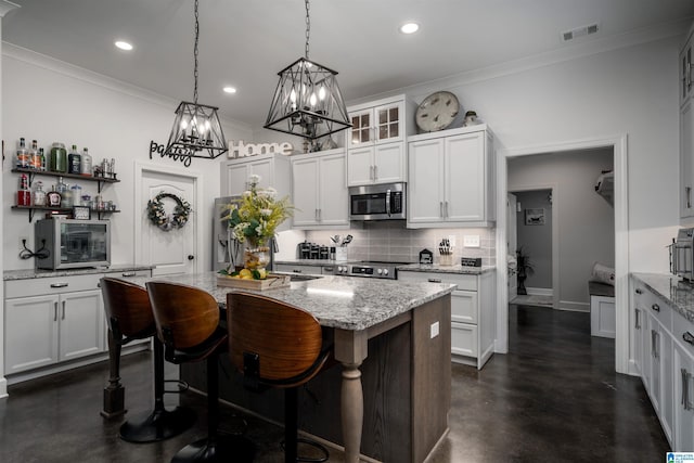 11967 Glen Ridge Blvd, Moundville, AL 35474 - kitchen featuring appliances with stainless steel finishes, finished concrete flooring, crown molding, backsplash, and a kitchen island