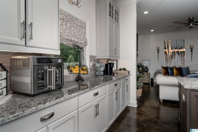 11967 Glen Ridge Blvd, Moundville, AL 35474 - kitchen featuring concrete flooring, a ceiling fan, open floor plan, white cabinetry, and recessed lighting