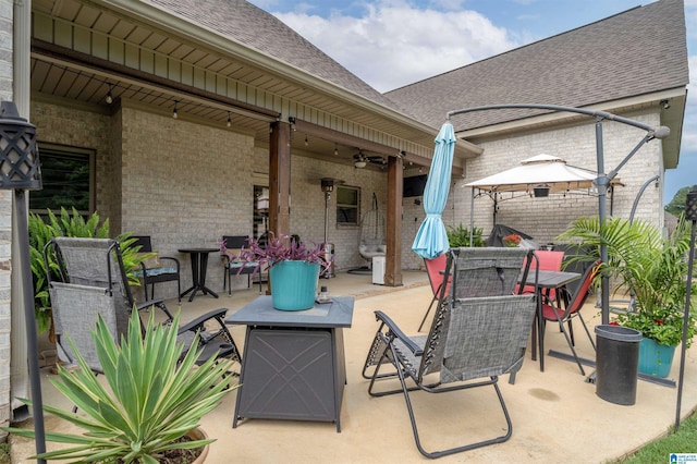11967 Glen Ridge Blvd, Moundville, AL 35474 - view of patio featuring a gazebo, outdoor dining space, ceiling fan, and an outdoor fire pit