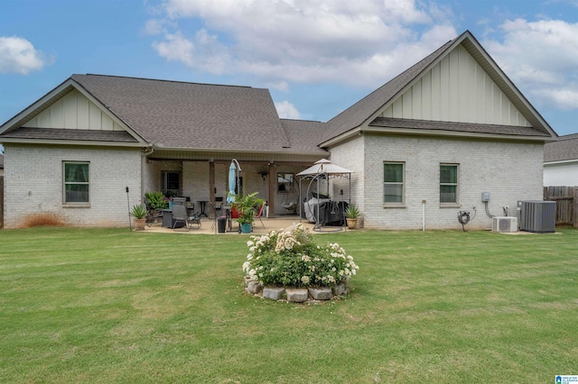 11967 Glen Ridge Blvd, Moundville, AL 35474 - rear view of house with board and batten siding, brick siding, a patio area, and a shingled roof
