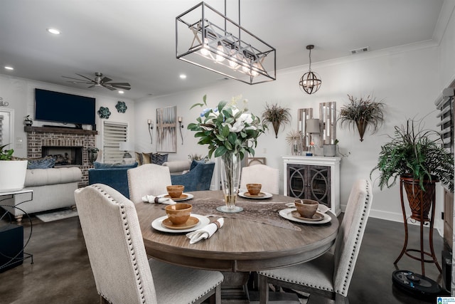 11967 Glen Ridge Blvd, Moundville, AL 35474 - dining area featuring a brick fireplace, a ceiling fan, finished concrete floors, crown molding, and recessed lighting