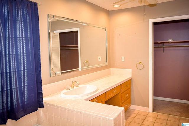 201 61st St, Fairfield, AL 35064 - bathroom with tile patterned floors, vanity, a ceiling fan, and a spacious closet