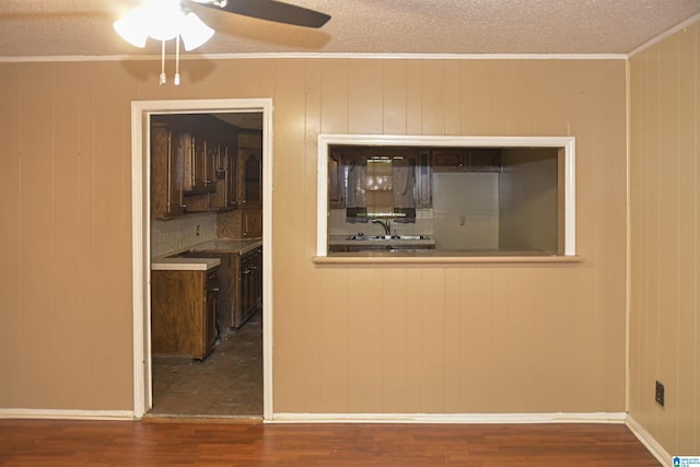 201 61st St, Fairfield, AL 35064 - empty room with wood finished floors, a ceiling fan, a textured ceiling, and crown molding