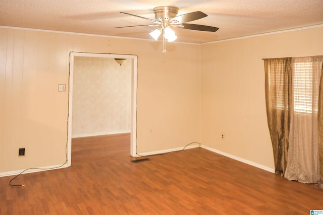 201 61st St, Fairfield, AL 35064 - empty room featuring crown molding, wood finished floors, a textured ceiling, and a ceiling fan