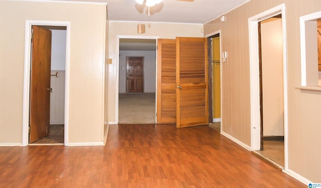 201 61st St, Fairfield, AL 35064 - unfurnished bedroom featuring a closet, ornamental molding, wood finished floors, and ceiling fan