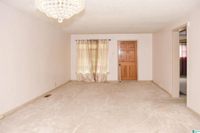 201 61st St, Fairfield, AL 35064 - carpeted spare room featuring a chandelier and baseboards