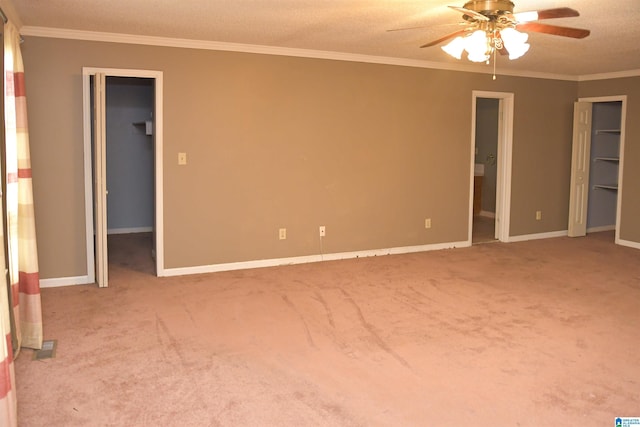 201 61st St, Fairfield, AL 35064 - unfurnished bedroom featuring a spacious closet, ornamental molding, carpet, connected bathroom, and ceiling fan