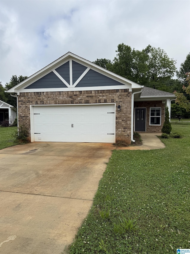 7257 Owen Park Cir, Mccalla, AL 35111 - view of front of home with brick siding, a front yard, driveway, and an attached garage