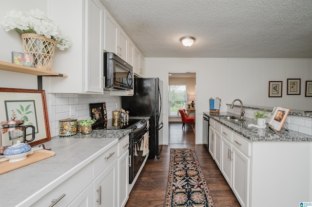 2304 Haden St, Hoover, AL 35226 - kitchen featuring black microwave, range with electric stovetop, white cabinetry, tasteful backsplash, and a textured ceiling