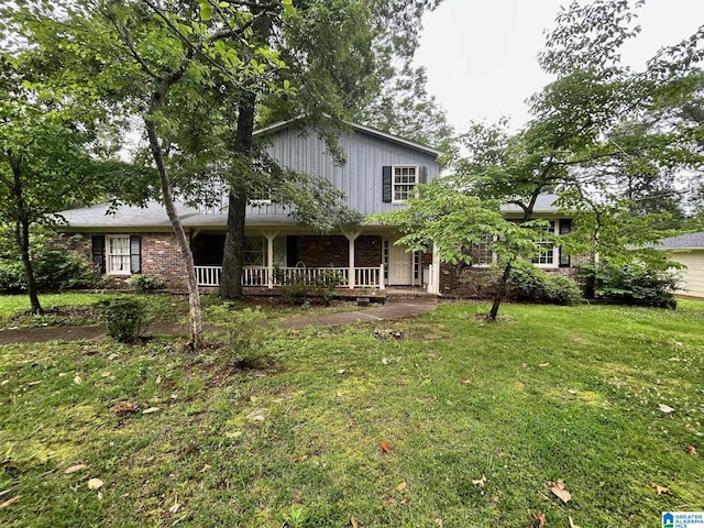 2341 Regent Ln, Hoover, AL 35226 - view of front of house with covered porch, a front lawn, and brick siding