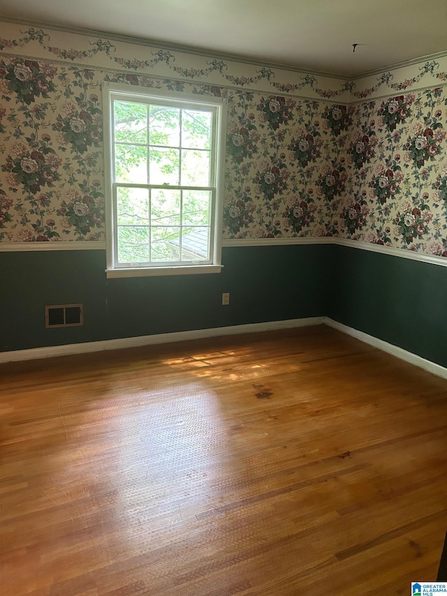 2341 Regent Ln, Hoover, AL 35226 - spare room featuring wainscoting, wallpapered walls, wood finished floors, and ornamental molding