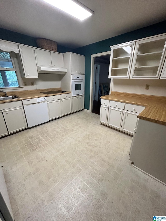2341 Regent Ln, Hoover, AL 35226 - kitchen with white appliances, under cabinet range hood, white cabinetry, and butcher block counters