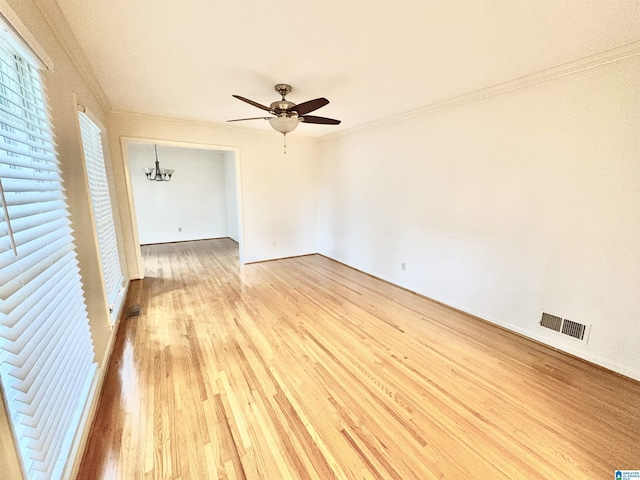 132 38th Ave NE, Center Point, AL 35215 - empty room featuring crown molding, light wood-style floors, ceiling fan, and a chandelier