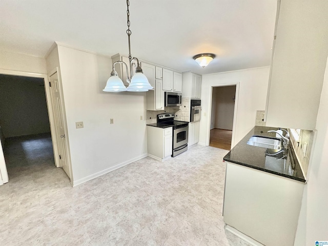 132 38th Ave NE, Center Point, AL 35215 - kitchen featuring appliances with stainless steel finishes, light flooring, dark countertops, white cabinets, and backsplash
