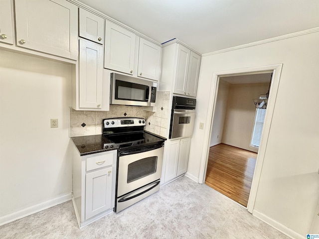 132 38th Ave NE, Center Point, AL 35215 - kitchen featuring stainless steel appliances, decorative backsplash, dark stone counters, and white cabinets