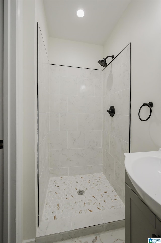 201 Sun Valley Rd, Center Point, AL 35215 - bathroom featuring a tile shower, vanity, and marble finish floors