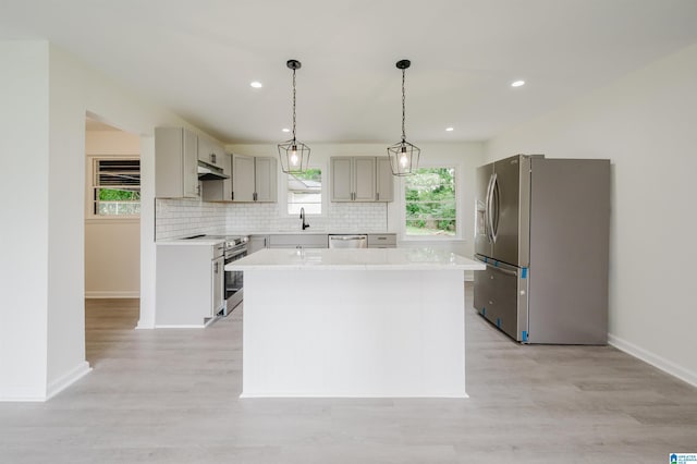201 Sun Valley Rd, Center Point, AL 35215 - kitchen featuring appliances with stainless steel finishes, tasteful backsplash, light countertops, light wood-style floors, and recessed lighting