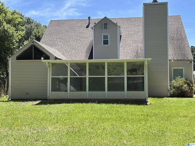 1221 Dalraida Rd, Montgomery, AL 36109 - back of property with a shingled roof, a sunroom, a chimney, and a yard