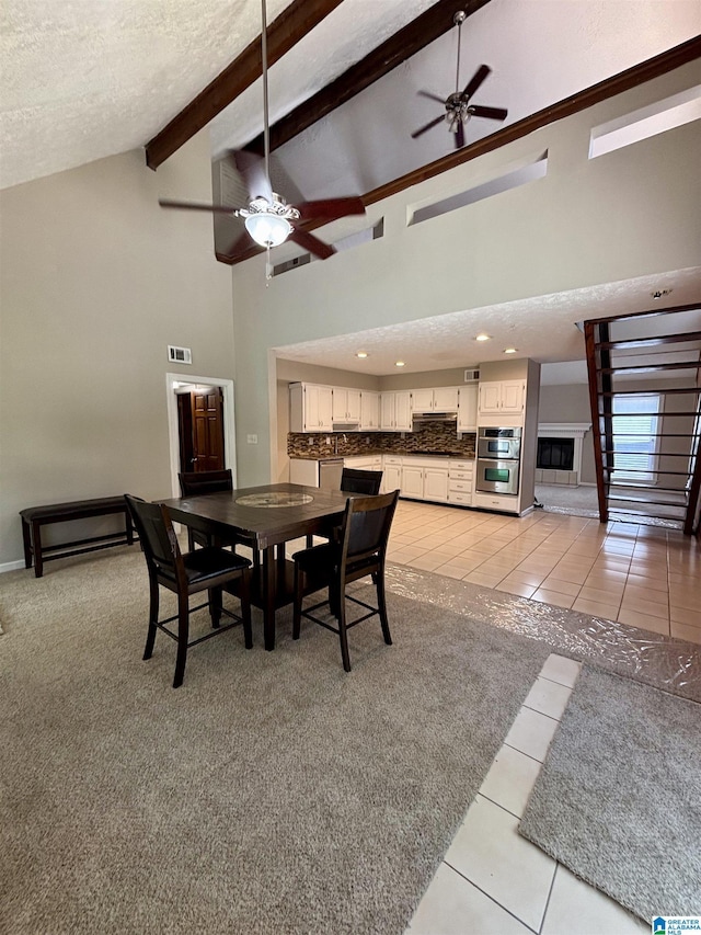 1221 Dalraida Rd, Montgomery, AL 36109 - dining area with ceiling fan, light tile patterned floors, high vaulted ceiling, beamed ceiling, and a textured ceiling