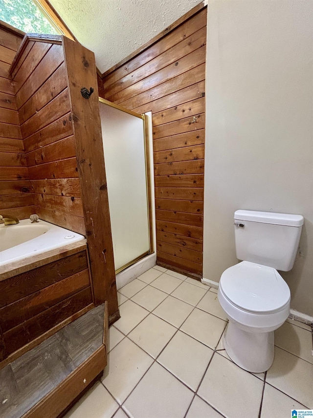 1221 Dalraida Rd, Montgomery, AL 36109 - bathroom with wooden walls, tile patterned floors, a textured ceiling, and a shower with shower door