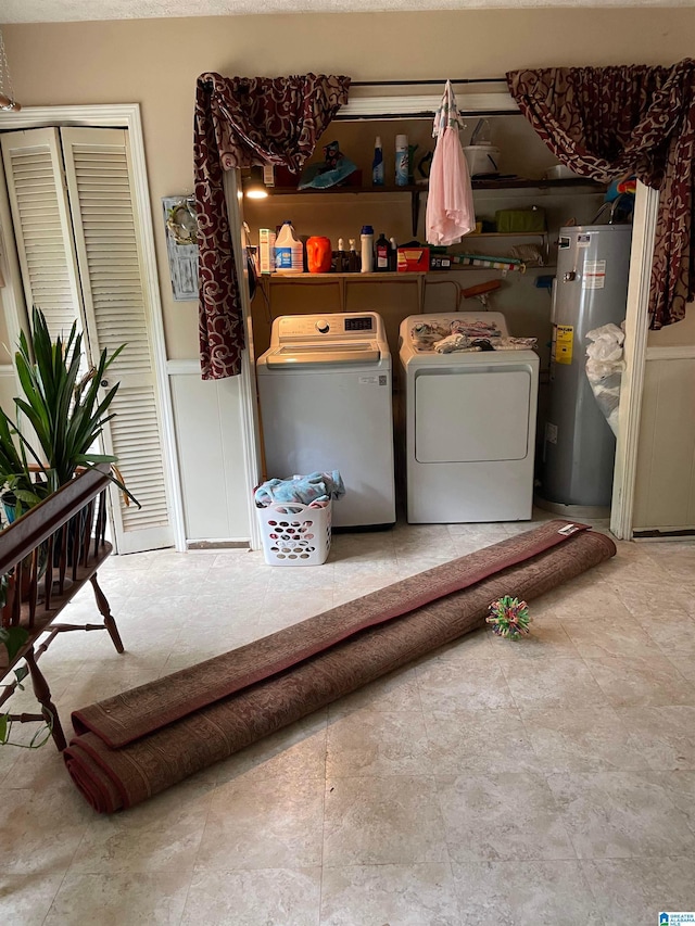 67 Evans Bridge Rd, Heflin, AL 36264 - washroom featuring water heater, washing machine and clothes dryer, and wainscoting