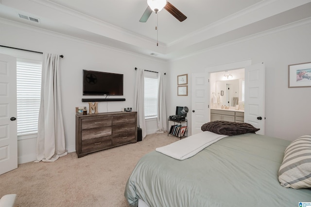 1268 Shades Ter, Irondale, AL 35210 - carpeted bedroom featuring multiple windows, ornamental molding, a tray ceiling, ensuite bath, and ceiling fan