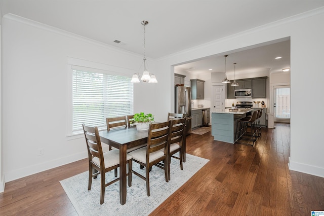 1268 Shades Ter, Irondale, AL 35210 - dining room with a chandelier, ornamental molding, and dark wood-style flooring