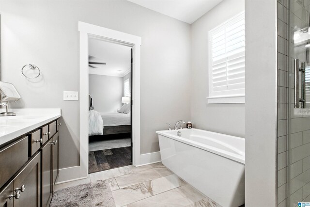 4855 Bo Run, Trussville, AL 35173 - ensuite bathroom featuring a garden tub, plenty of natural light, vanity, and marble look tiles