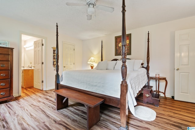 2690 Ingate Pass, Centreville, AL 35042 - bedroom featuring light wood-type flooring, ensuite bath, ceiling fan, and a textured ceiling
