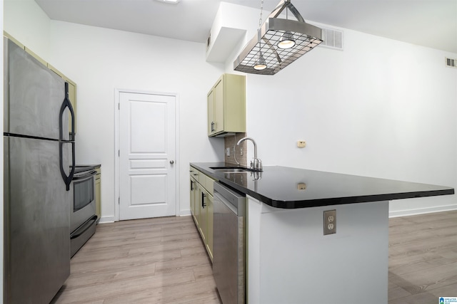 401 20th St S Unit 126, Birmingham, AL 35233 - kitchen featuring appliances with stainless steel finishes, dark countertops, light wood finished floors, and a peninsula