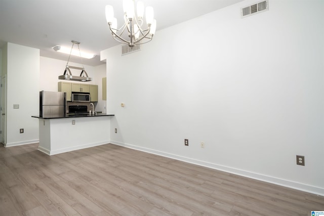 401 20th St S Unit 126, Birmingham, AL 35233 - kitchen with stainless steel appliances, dark countertops, light wood-style flooring, and a peninsula