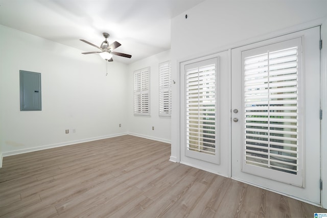 401 20th St S Unit 126, Birmingham, AL 35233 - unfurnished bedroom featuring electric panel, access to exterior, light wood-type flooring, and a ceiling fan