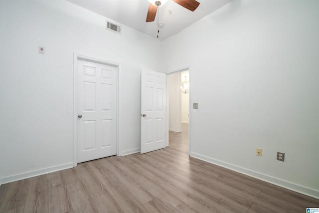 401 20th St S Unit 126, Birmingham, AL 35233 - unfurnished bedroom with wood finished floors, ceiling fan, and a towering ceiling