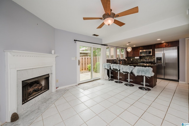 3655 Haven View Cir, Hoover, AL 35216 - kitchen featuring appliances with stainless steel finishes, a kitchen breakfast bar, backsplash, a peninsula, and dark brown cabinets