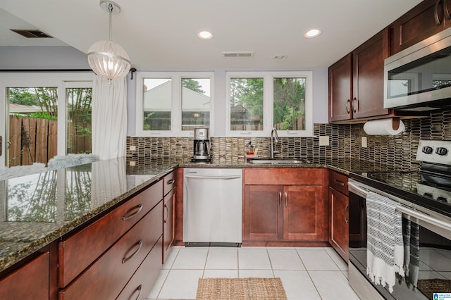 3655 Haven View Cir, Hoover, AL 35216 - kitchen featuring appliances with stainless steel finishes, tasteful backsplash, dark stone counters, light tile patterned flooring, and recessed lighting