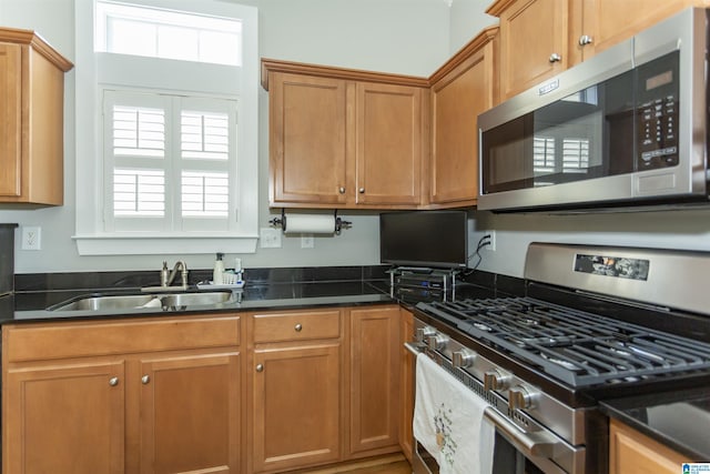 4650 Nicholas Dr, Bessemer, AL 35022 - kitchen featuring appliances with stainless steel finishes, brown cabinets, and dark stone counters