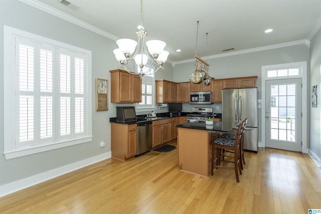4650 Nicholas Dr, Bessemer, AL 35022 - kitchen with appliances with stainless steel finishes, a kitchen bar, light wood finished floors, crown molding, and recessed lighting
