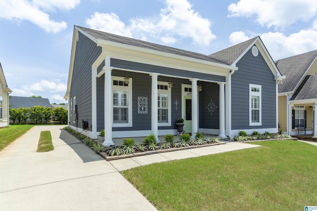 4650 Nicholas Dr, Bessemer, AL 35022 - view of front of home featuring concrete driveway, a front lawn, covered porch, and roof with shingles